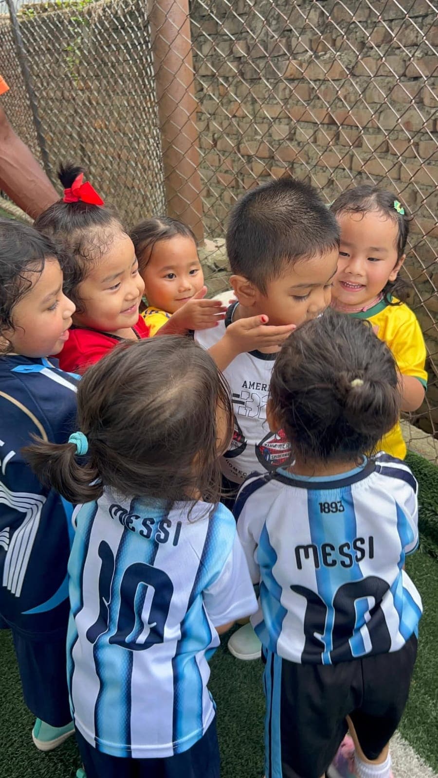 A huddle of tiny footballers in their favourite jerseys