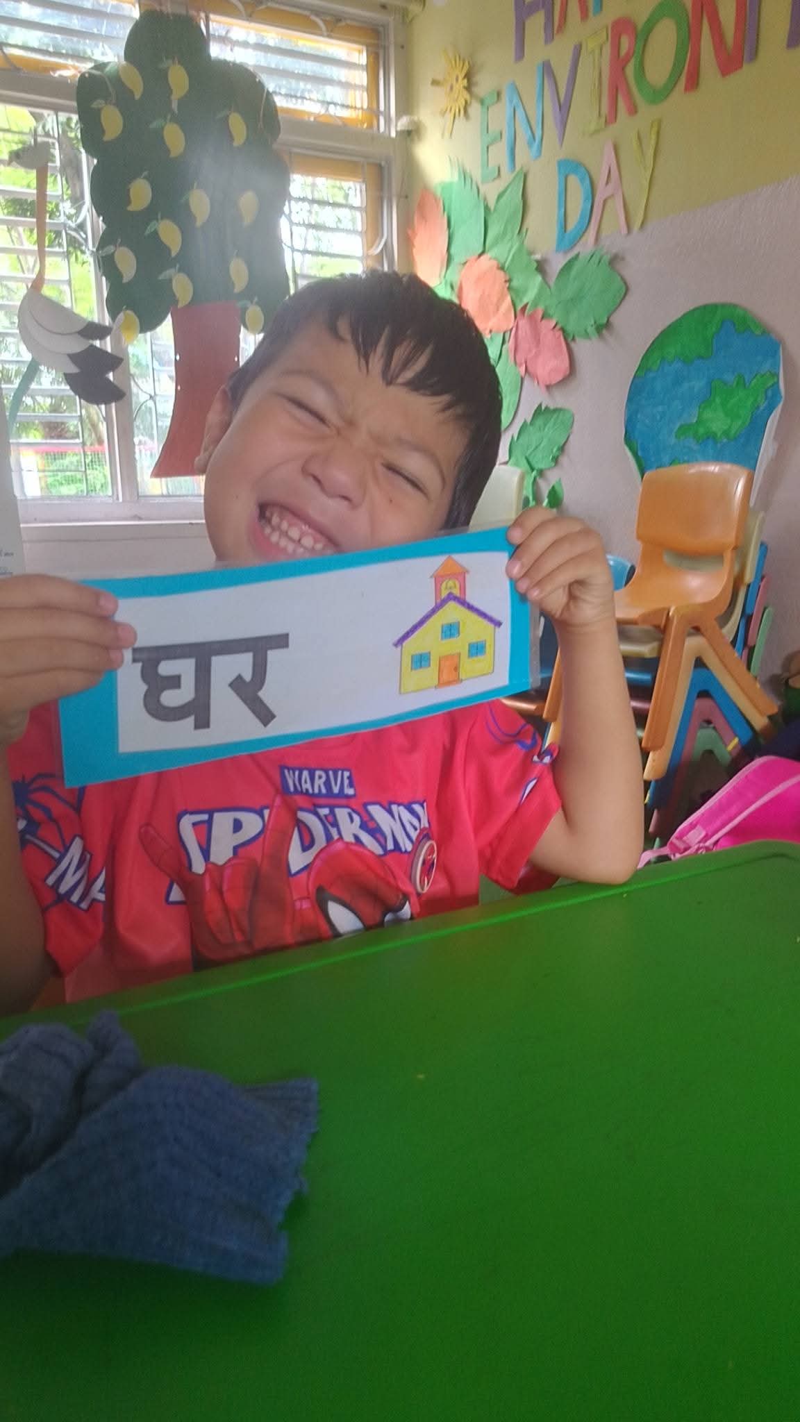 A delighted student showing off his Nepali flashcard