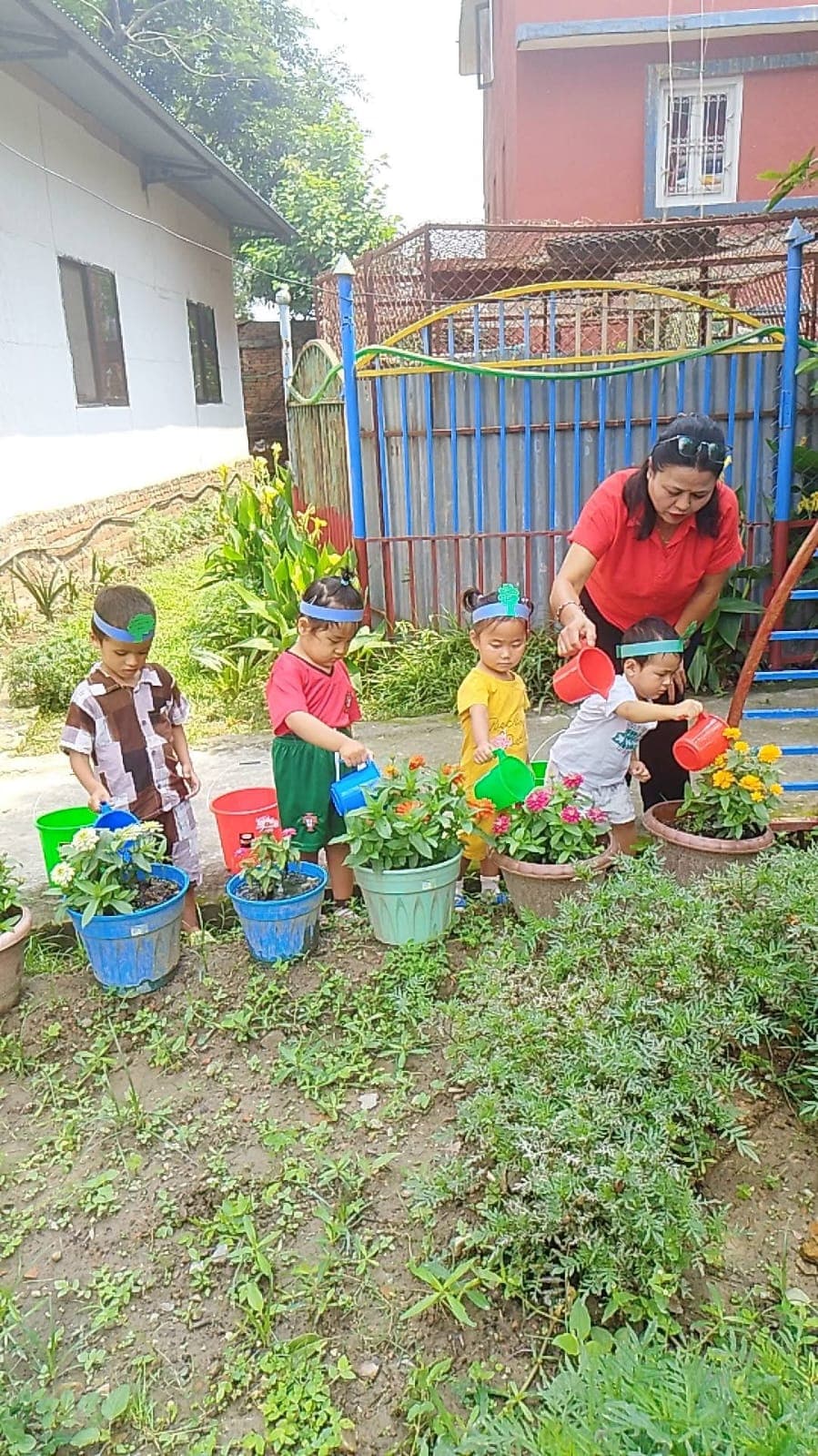 Little gardeners watering flower pots on Environment Day
